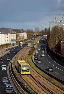 Essen, North Rhine-Westphalia, Germany - Cars and a public bus drive through Essen city centre on
