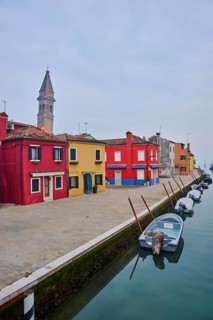Colorful houses beside the waterway at 'Fondamenta di Pizzo' with boats lying in the water on the