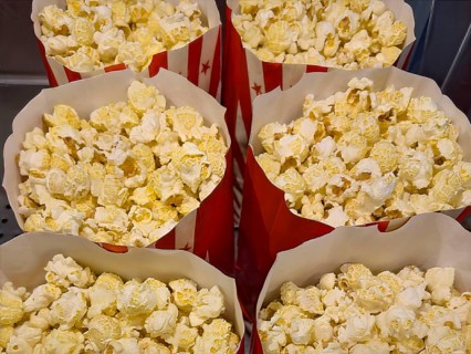 Several open large paper bags with snack popcorn puffed corn popping corn, international
