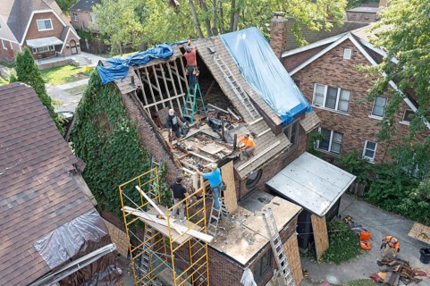 Detroit, Michigan, Workers rebuild the attic of a house damaged when a storm blew down a 15-ton,