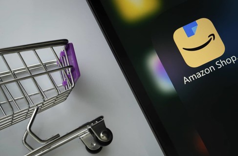A close up of an iPad screen displaying the amazon shopping app alongside a mini shopping cart