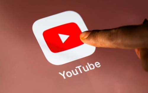 In this photo Illustration a person taps Googles Youtube application on a tablet device on 24 May