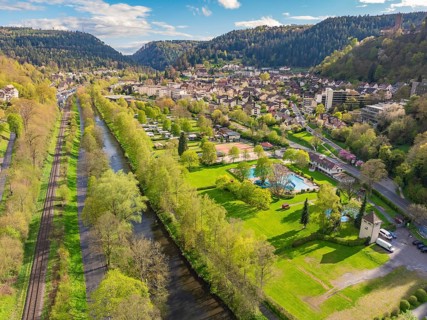 River and railway tracks cross green landscape next to town, Bad Liebenzell, district of Calw,