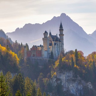 Neuschwanstein Castle in the sunlight, embedded in autumnal landscape, Neuschwanstein, Schwangau,