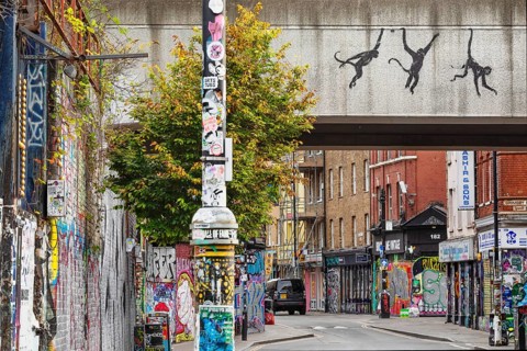Banksy graffiti of the three monkeys in Brick Lane, East End, London, England, Great Britain,