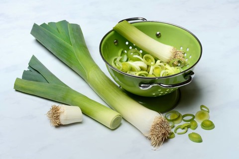 Leek, leek sticks and leek rings in a sieve bowl