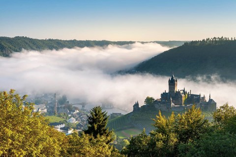 View of Cochem with the Reichsburg in autumn, morning mist in the Moselle valley, Cochem,