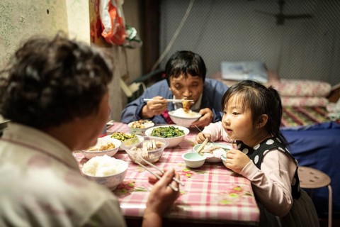 Gao Jian Min (67), Lin Shu Xiang (56) and Gao Xin Rui (5) having dinner, the grandmother bought