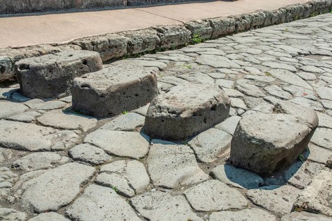 Stepping stones above perpetually flowing water needed to cross streets and keep the way clear for