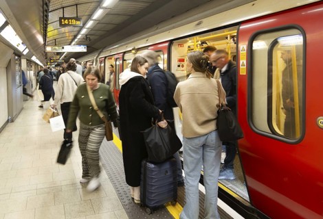 Crowded underground tube train arriving at station platform, Kings Cross Station, London, England,