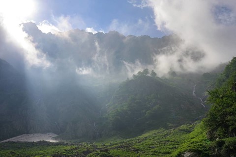 Clouds move over the mountains after a rain shower at Lago della Rovina, Entracque, province of