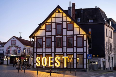 Letters form the word Soest in front of a half-timbered house, Blue Hour, Soest, North