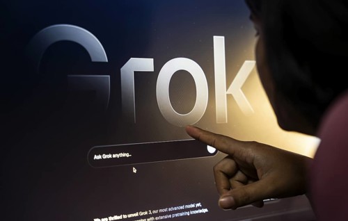 In this photo illustration, a person uses Grok AI chatbot on a mobile phone on March 21, 2025 in