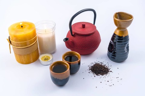 Japanese tea with candles and a cup and Japanese glasses