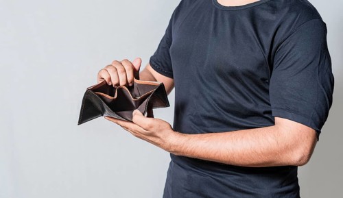Hands of bankrupt person showing an empty wallet isolated. Man's hands in financial crisis showing