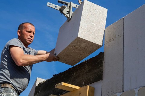 Bricklayer works on a new detached house