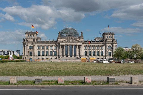 Front view of the Reichstag with a street in the foreground, under a cloudy sky, Berlin, Germany