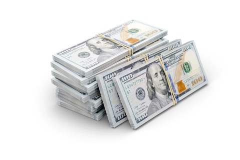 Stacks of thousands of one hundred dollar bills bound by a rubber band isolated on a white