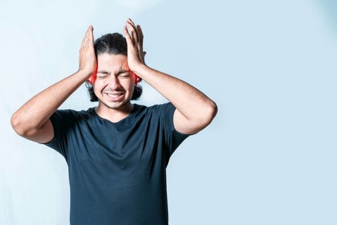 Suffering person with migraine massaging head isolated. Headache and migraine concept