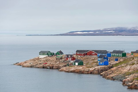 Colourful houses on a rocky coastal landscape, remote Arctic Inuit settlement Ittoqqortoormiit,