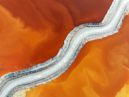 Track crossing a waste pond in the mineral-rich area of the Rio Tinto mines. The colour is caused