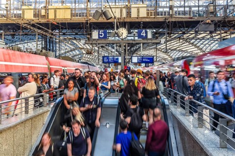 Cologne Central Station. Stairs to the platforms. Travellers waiting for their train on the