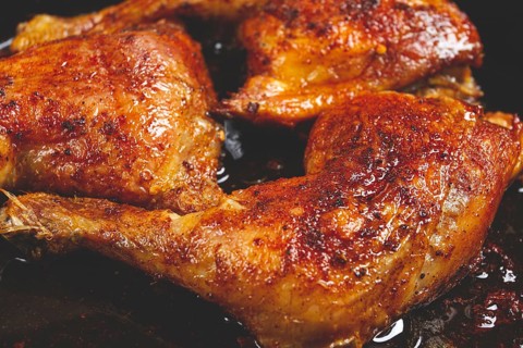 Baked chicken legs, with crispy skin, served in a pan, rustic style, homemade, no people