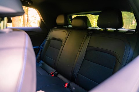 Interior of a car with black rear seat bench and modern elegance in the forest, Deer E- Carsharing,