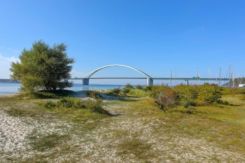 Beach in front of Fehmarnsund Bridge, connects the island of Fehmarn in the Baltic Sea with the