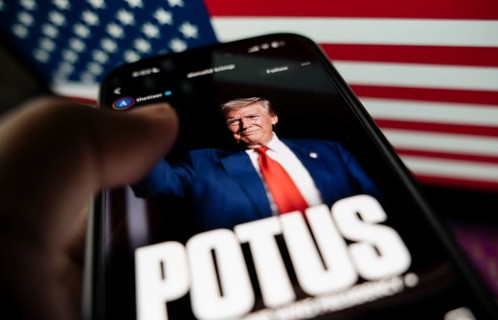 In this photo illustration, a person looks Donald Trump image on a smartphone after results of U.S.