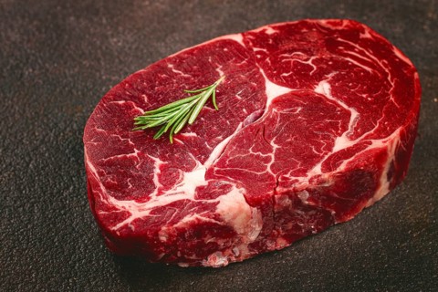 Fresh beef steak, close-up on a dark background, no people