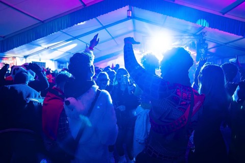 Lively party atmosphere with costumed people and light effects, carnival, Schlagerkuchen Donzdorf,