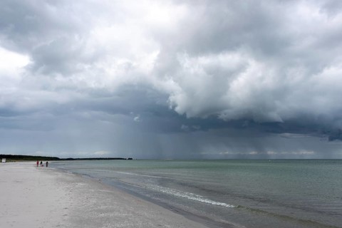 Thick, dark rain clouds gather over the Baltic Sea, Prerow, Mecklenburg-Vorpommern, Germany