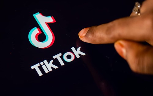 In this photo Illustration a person browsing taps Tiktok Application on a tablet device on 24 May