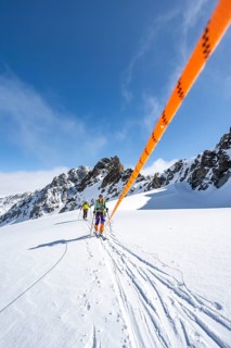 Ski tourer with rope, rope team on the Vadret da Porchabella glacier on the ascent to the summit of