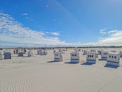 Preparing for the high season on the beach, setting up the numbered beach chairs, North Sea, on the