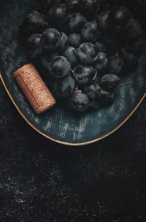Bunch of black grapes, in a bowl with a wine stopper, Saperavi grape variety, Georgian culture, top