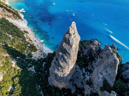 Picturesque rocky coast, cliffs with L'Aguglia pinnacle, blue sea and Cala Goloritzé beach, aerial