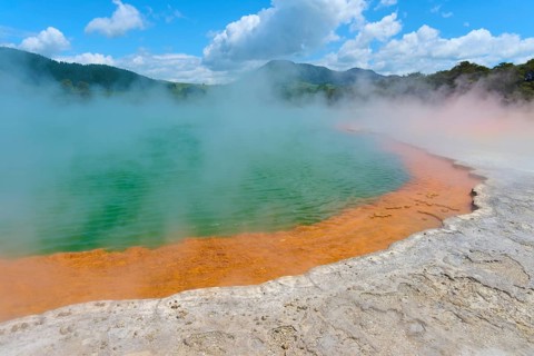 Hot spring with steam surrounded by a picturesque landscape, Champagne Pool thermal lake,