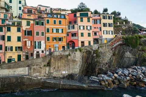 Colourful residential apartment buildings and bay in Riomaggiore village, Cinque Terre, La Spezia