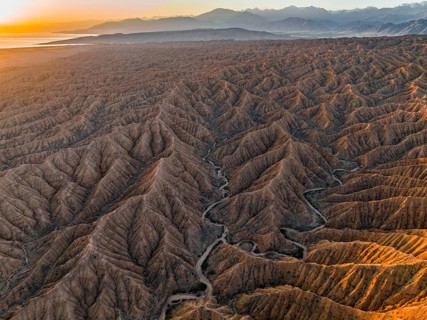 Landscape of eroded hills at Lake Issyk Kul, Badlands at sunrise, aerial view, Canyon of the