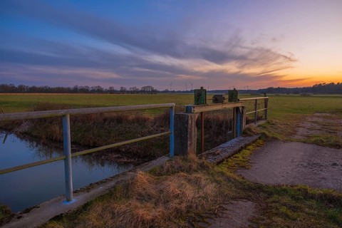 View of a sluice and a bridge with a pasture behind it at sunset, Kirchlinteln, Verden, Aller Leine