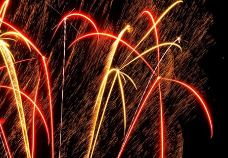 New Year's Eve fireworks, vivid fireworks in the night sky with golden, yellow, red and blue