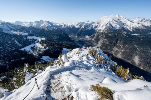 Hiking trail on the snow-covered summit of the Jenner with viewing platform in autumn, view of
