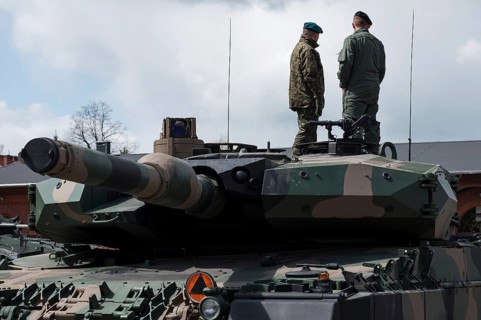 Soldiers on the top of tank.