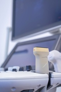 Medical ultrasound probe in front of a screen in a clinical environment, Urology, Germany