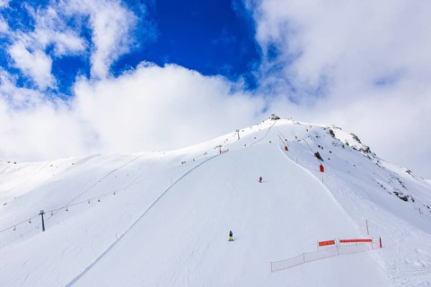 Skiers in the ski area at the summit of Corne de Sorebois, Val d'Anniviers, Valais Alps, Canton