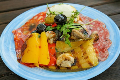 Mediterranean cuisine, grilled vegetables arranged on plates, mushrooms, mushrooms, red and yellow