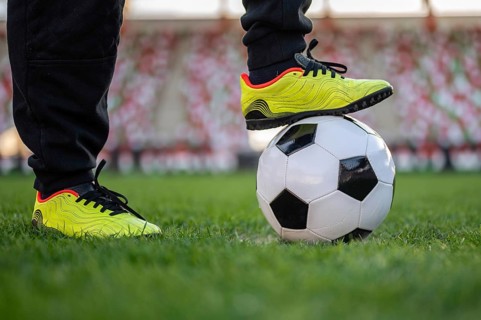 Soccer ball and leg of young player on the ball