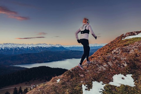 Trail running in autumn on the Jochberg on Lake Walchensee against the wonderful backdrop of the